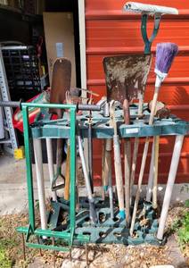 lot 504 image: TOOL ORGANIZER WITH 15 TOOLS INCLUDING SLEDGEHAMMERS, SHOVELS, PRUNERS, HAND TILLER, AND MORE AS SHOWN. (YOUR BID X 15)