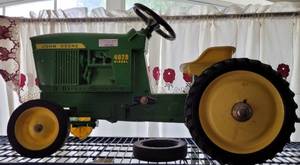lot 523 image: VINTAGE ERTL JOHN DEERE 4020 DIESEL PEDAL TRACTOR WITH WAGON AS SHOWN. TRACTOR MEASURES APPROX. 32 LONG X 17.5 W. ONE WHEEL NEEDS WORK. SEARCH IT UP