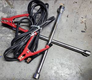 lot 874 image: JUMPER CABLES AND 4-WAY TIRE LUG WRENCH AS SHOWN.