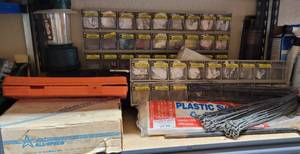 lot 884 image: HARDWARE STORAGE COMPARTMENT BOXES, PLASTIC SHEETING, LANTERN, STAPLES AND MORE AS SHOWN.
