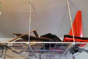 lot 896 image: CEILING WIRE STORAGE RACK WITH CONTENTS AS SHOWN. BUYER IS RESPONSIBLE FOR PROPER REMOVAL. DELAYED PICK UP -- SATURDAY AFTER 400 PM OR SUNDAY