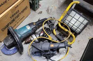 lot 899 image: MAKITA ANGLE GRINDER, BLACK & DECKER DRILL AND SANDER PLUS HALOGEN LAMP AS SHOWN. (YOUR BID X 4)