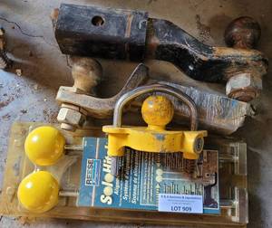 lot 909 image: (2) TRAILER HITCH BALL MOUNTS, (1) REESE SOLOHITCH ALIGNMENT SYSTEM IN PACKAGE, AND TRAILER HITCH LOCK (NO KEY) AS SHOWN.