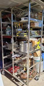 lot 972 image: LARGE CART WITH PULLOUT BASKET SHELVES ON CASTERS AS SHOWN. ONE CASTER NEEDS WORK. CONTENTS NOT INCLUDED. DELAYED PICK UP -- SATURDAY AFTER 400 PM OR SUNDAY