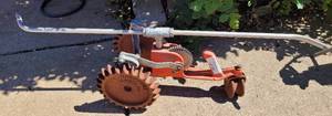 lot 989 image: VINTAGE THOMPSON CAST IRON TRACTOR SPRINKLER AS SHOWN.