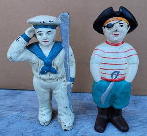 lot 1034 image: LOT OF 2 VINTAGE CAST IRON FIGURE COIN BANKS INCLUDING (1) SAILOROARSMAN AND (1) PIRATE AS SHOWN. APPROX. 6 HIGH EACH. (YOUR BID X 2)
