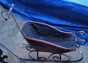 lot 1066 image: VINTAGE SLEIGH WITH METAL FRAME AND WOOVEN STYLE TOP AS SHOWN.