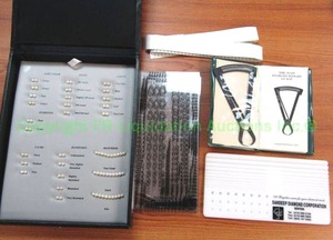 lot 155 image: Diamond and pearl tools including GIA approved cultured pearl master comparison set, JO-DI diamond weight gauge and cellophane size guides