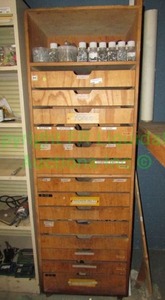 lot 220 image: Wood 14-drawer cabinet with reach in handles and top shelf. Contents included. 72x24x36 in