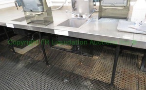 lot 470 image: Stainless steel table with double sink unit, 84x48x24 in. Buyer to remove. Please bring assistance (steam units not included)