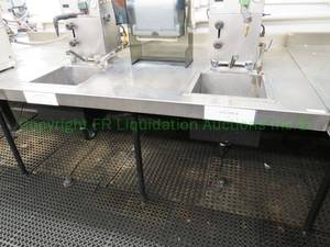 lot 479 image: Stainless steel table with double sink unit, 24x48x60 in. Buyer to remove. Please bring assistance (Steam unit not included)