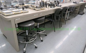 lot 521 image: Laminate and wood counter unit with drawers, 27ft long. Buyer to remove. (Contents not included)
