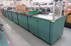 lot 555 image: Laminate top double sided work station with plexiglass safety guard. 27ft long (Contents not included)