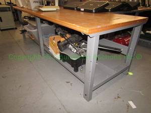 lot 263 image: Wood top metal base work table, 2x8x3 ft. Buyer to remove Please bring assistance Contents not included