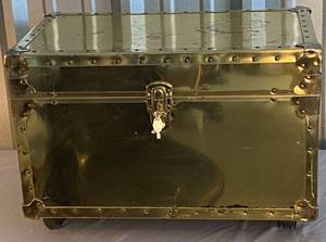lot 96 image: Brass colored trunk with wheels