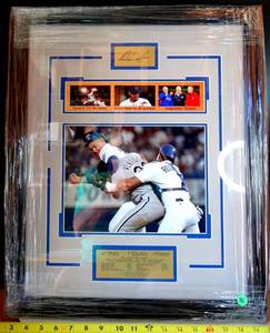 lot 96 image: NOLAN RYAN LEGENDARY MOMENTS- FRAMED & MATTED PHOTO DISPLAY WITH METAL FACSIMILE SIGNATURE & BIO PLATE - MEASURES 16 X 20