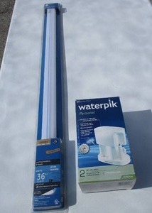 lot 57 image: Personal Water Pick And Unopen-GE 110-V 36-Slim Line Fluorescent Fixture With Bulb, 5-Ft Cower And OnOff Rocker Switch.