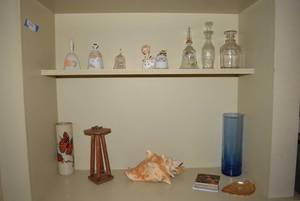 lot 9 image: Contents of 2 Shelves Bells, Nut Cracker, Conch Shell
