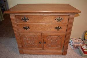 lot 32 image: Antique Oak Cabinet with Wheels, Back is stamped Antique