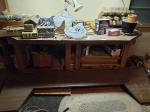 lot 323 image: Contents of Work Table Terminate Home Defense, Motion Security Light, Grinder, Work light, Radio
