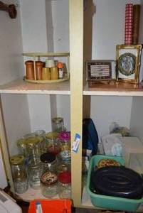 lot 162 image: Contents of Kitchen Cabinet Spirit of St. Louis Clock, Christmas Photo Album, Lazy Susan Spice Rack and Hamburger Press