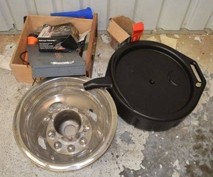 lot 71 image: Metal Storage Box with Dividers, Box of Lug Bolts, Oil Drip Container, Wheel Rim, see pictures