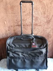 lot 128 image: TUMI MULTI POCKETED TRAVEL BAGS ON ROLLERS WITH PULL HANDLE - $$$