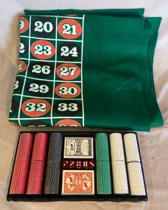 lot 22 image: Poker Chips 300 Sealed, 2 decks of sealed cards, 5 dice, full size green felt one side is Roulette the other is plain.
