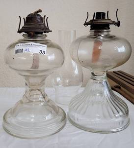 lot 35 image: LOT OF 2 VINTAGE GLASS OIL LAMPS AS SHOWN. ONE HAS THE GLASS HURRICANE. (YOUR BID X 2)