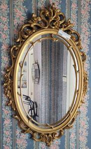 lot 140 image: GOLD TONE FRAMED OVAL MIRROR IN STYLE SHOWN. Approx. 18 x 29.