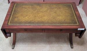 lot 175 image: ANTIQUE LEATHER TOP DROPLEAF COFFEE TABLE IN STYLE, COLOR, AND CONDITION SHOWN. TAKE A LOOK Approx. 50.5 w x 20 d x 16 h (extended.)