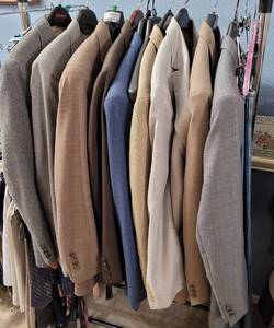 lot 214 image: LOT OF 9 SUITSJACKETS INCLUDING TOMMY HILFIGER, OSCAR DE LA RENTA, THE SANS BELT SUIT, CHAPS AS SHOWN.