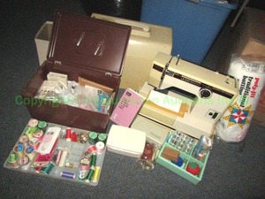 lot 140 image: Montgomery Ward sewing machine model UHT-J-1943 and assorted sewing notions