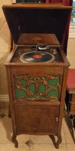 lot 1 image: Antique Cecilian Melophonic hand crank monograph with carved wood cabinet as shown.