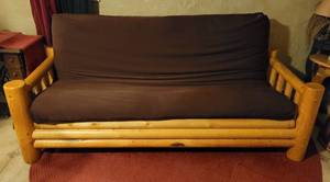 lot 6 image: Log-style frame futon with mattress in solid overall condition as shown.
