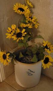 lot 22 image: Vintage Blue Bird 3 gallon stoneware crock with floral arrangement as shown.