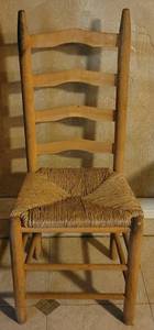 lot 29 image: Vintage wood ladder back chair with rush seat as shown.
