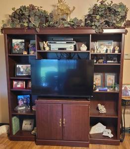 lot 41 image: Large size entertainment center in style, color, and condition shown. Contents not included