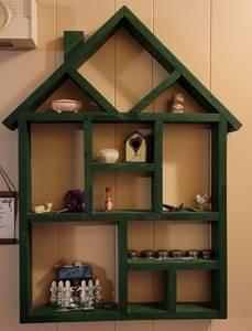 lot 50 image: Wooden house shaped wall display with contents as shown.