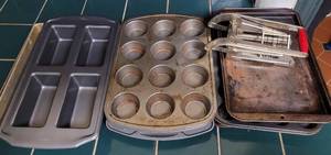 lot 75 image: Lot of baking, muffin and loaf pans plus potato cutter as shown.