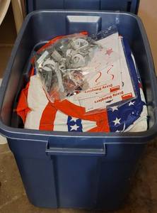 lot 95 image: Plastic tub full of 4th of July, patriotic, Texas themed table covers and more as shown.