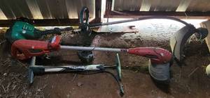 lot 232 image: Cordless Black & Decker and Feather Light Trimmers as shown.