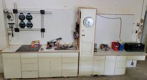lot 202 image: LARGE SHOP CABINETS WITH WORKSPACE AND PEGBOARDS AS SHOWN. CONTENTS SHOWN NOT INCLUDED APPROX. 91 L x 24 D x 88 H.