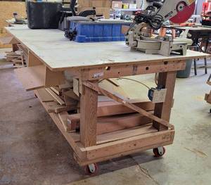lot 214 image: LARGE SIZE SHOP-MADE WORKTABLE ON WHEELS AS SHOWN. MEASURES APPROX. 147 L x 49 W x 35 H. CONTENTS SHOWN NOT INCLUDED.