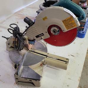 lot 215 image: MAKITA LS1011 10 SLIDE COMPOUND MITER SAW AS SHOWN.