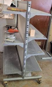 lot 257 image: COMMERCIAL DOUBLE SIDED SHELVINGDISPLAY UNIT ON WHEELS AS SHOWN. CONTENTS NOT INCLUDED. APPROX. 50 L x 32 W x 61.5 H.