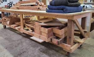 lot 332 image: LARGE SIZE SHOP-MADE WORKTABLE ON WHEELS AS SHOWN. MEASURES APPROX. 144 L x 49 W x 37 H. CONTENTS SHOWN NOT INCLUDED