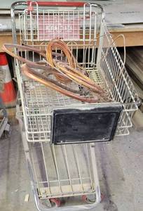 lot 404 image: COPPER PIPE PLUS SHOPPING CART AS SHOWN.