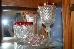 lot 60 image: Ruby Trim Candy Dish, Ruby Trim and Diamond Cut Glass Compote, and Cranberry and Crystal Swirl Bowl