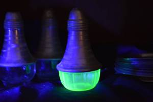 lot 247 image: Aluminum and Uranium Glass Skaker, Aluminum and Clear Glass Salt and Pepper Shakers Plus Hand Forged Coasters